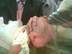 An infant being baptized