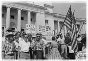 Crowds protesting the integration of Little Rock schools