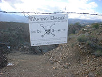 This danger sign at an old Arizona mine warns, "Stay Out! Stay Alive!"